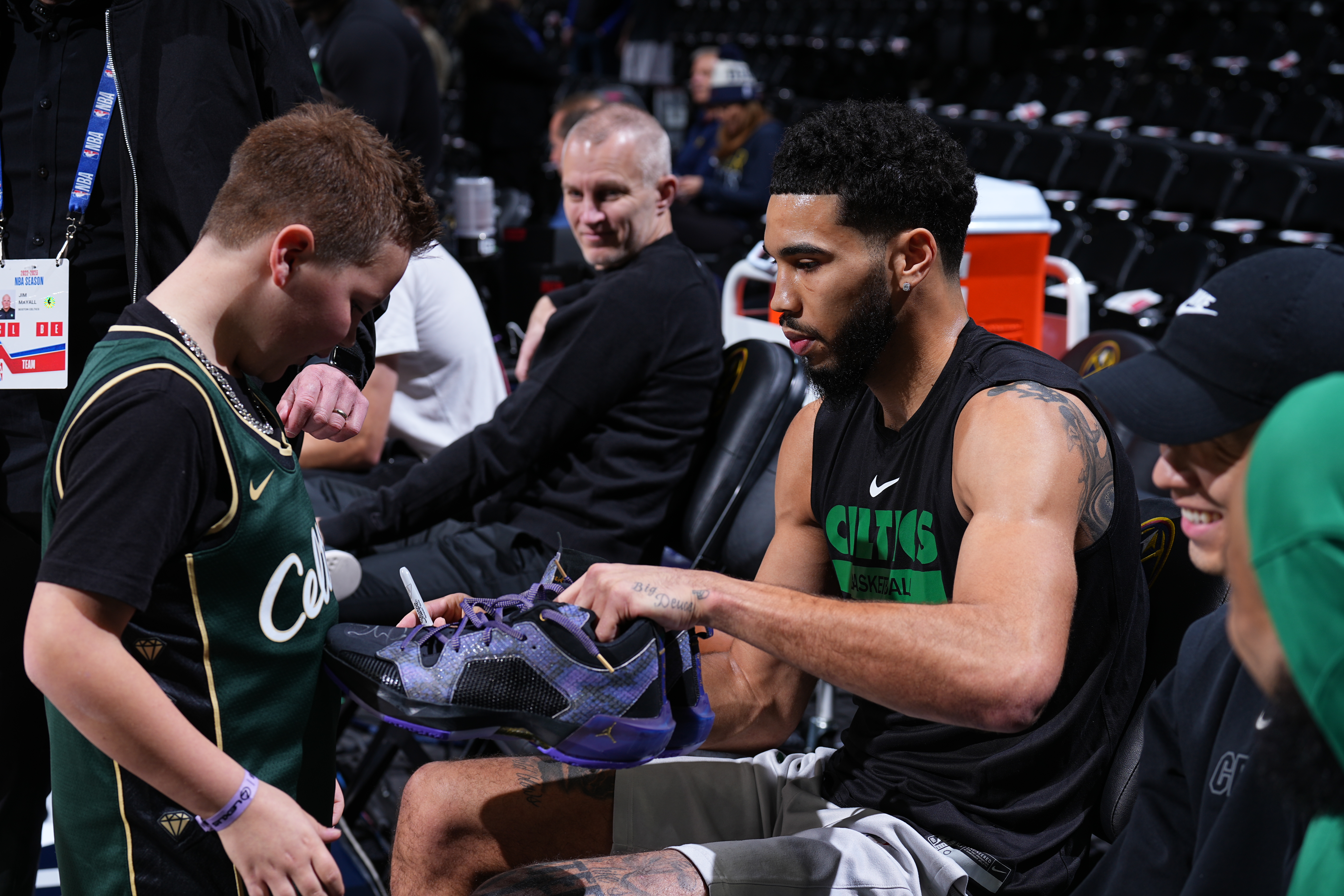 Tatum gifts a pair of his shoes to a Celtics fan