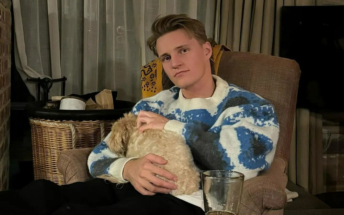 Odegaard was also snapped with the puppy sat on his lap